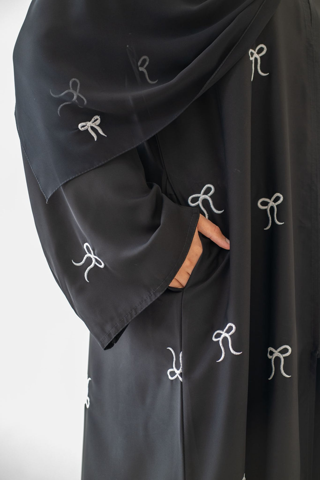 Model wearing Black Button Abaya with Bow Detail outfit