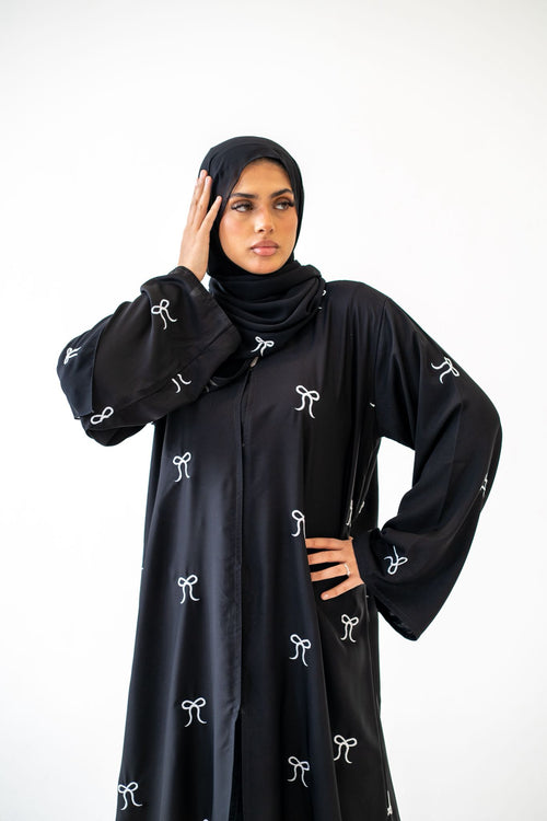 Front view of Black Button Abaya with Bow Detail modest design
