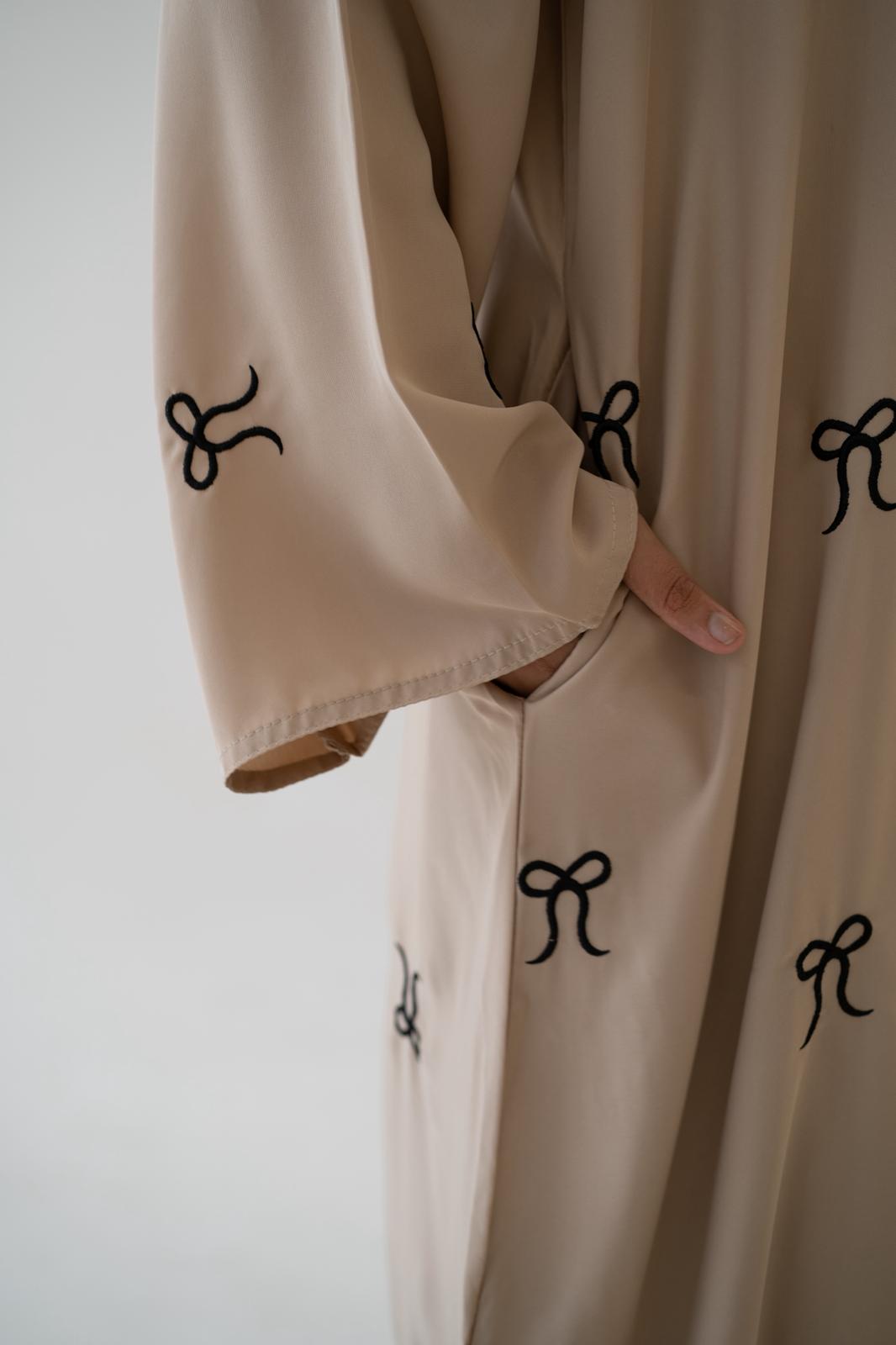 Elegant styling of Black Button Abaya with Bow Detail